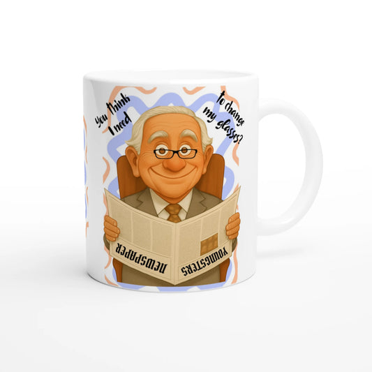 White ceramic mug with colorful funny design of a grandfather reading a newspapper upside down.