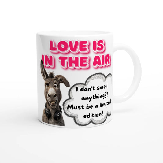 White mug with a printed design saying LOVE IN THE AIR with a donkey confused face saying a funny quote as a single.