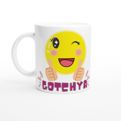 White ceramic mug with printed colorful design  of a cute smiling emoji winking saying GOTCHYA