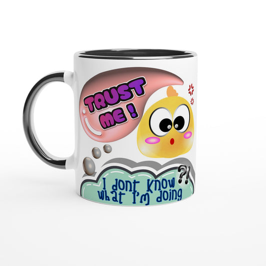 White ceramic mug with colored black inside and handle with colorful playful printed design of a cute face of a chick saying TRUST ME but thinking I dont know what I'm doing