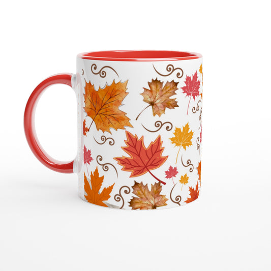 White ceramic mug with wolored red inside and handle with a warm colored design of automn leaves.